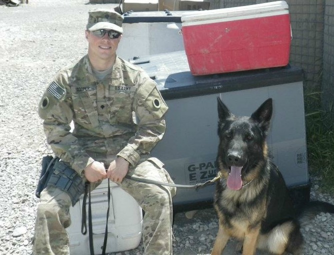 Army Spc. Devin Cooper with his MWD Panter, who developed PTSD and could not finish his next tour of duty. Spc. Cooper still does not know who adopted Panter.